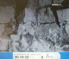 Forced laborers at Kahla 04: a pickax
                            on some rubble