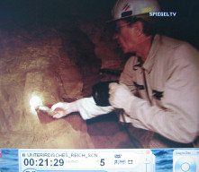 Doggerwerk near Hersbruck 12: tunnel
                          caretaker Rabe taking out an explosive
                          cartridge from a drill hole 01