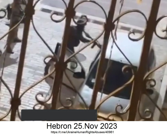 West Bank CC with Hebron: criminal Jewish Zionist soldier is hammering with his automatic gun against car windows whereas the door of the car is open (!) - Nov 25, 2023
