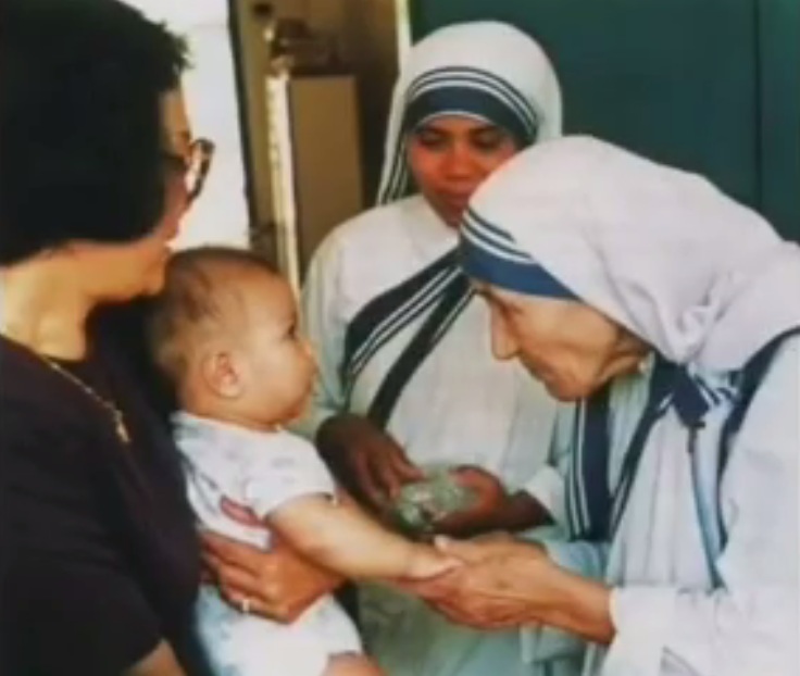 Mother
                Teresa is presented a baby