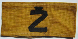 Yugoland, yellow armband with the
                          inscription "�" in black